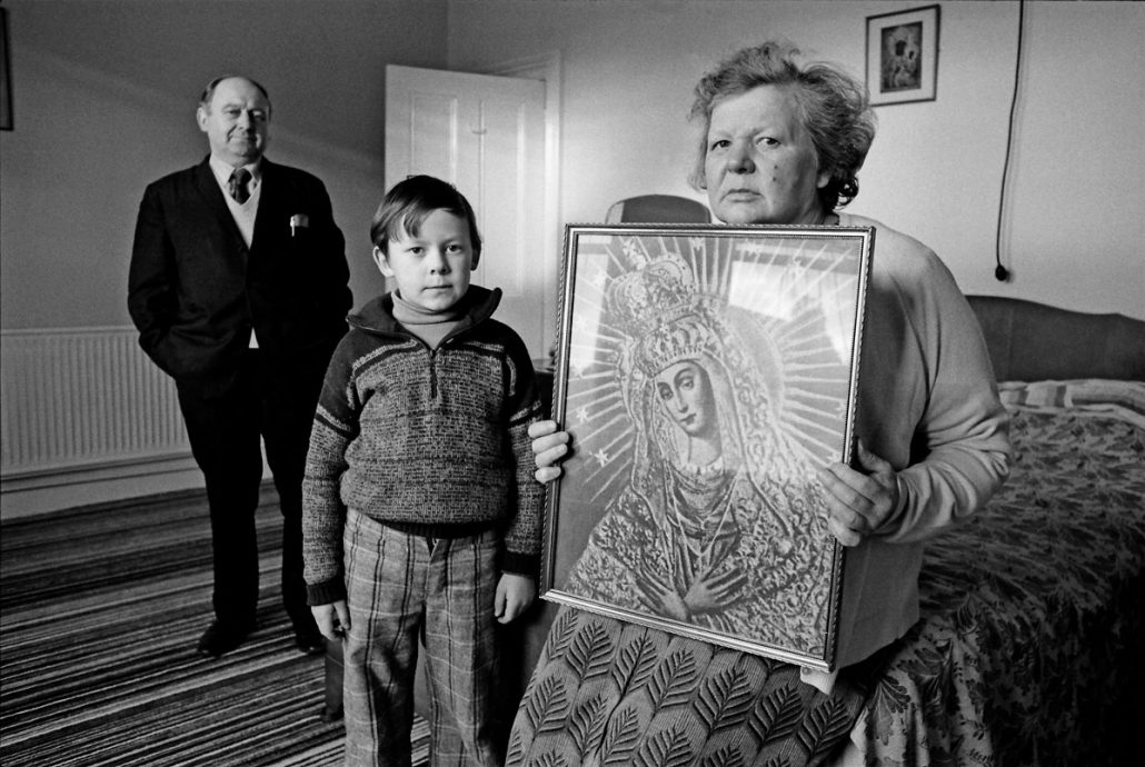 Helena holds a picture of Our Lady of the Gate of Dawn (Matka Boska Ostrobramska), Loughborough, Czeslaw Siegieda, documentary photographer